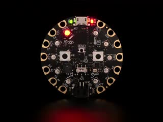 Video of a round microcontroller with lit up LEDs.