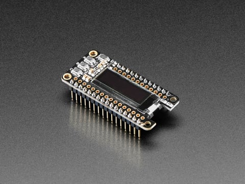 Angled shot of a Assembled Adafruit FeatherWing OLED - 128x32 OLED Add-on For Feather. 