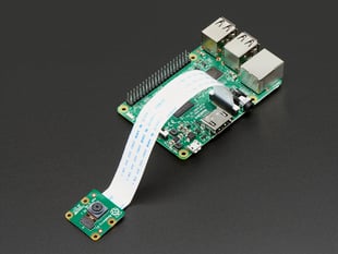 Angled shot of Raspberry Pi Camera Board v2 - 8 Megapixels connected to a flex cable and a Raspberry Pi.