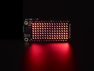 Video of a Adafruit 15x7 CharliePlex LED Matrix Display FeatherWing illuminating Red LEDs in a wave like pattern. 