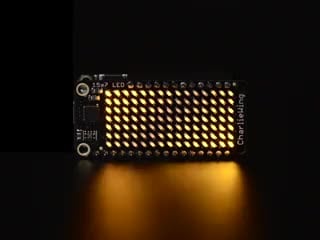 Video of a Adafruit 15x7 CharliePlex LED Matrix Display FeatherWing illuminating Yellow LEDs in a wave like pattern. 