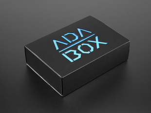 Angled shot of a black box with blue "ADABOX" texted logo.
