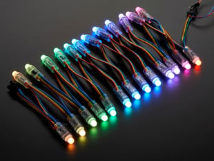 Array of many lit up LED pixel dots on wire strand, rainbow colored