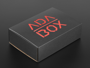 Angled shot of a black box with Red "ADABOX" texted logo.