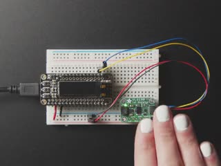 Video of a white hand hovering over a Adafruit VL6180X Time of Flight Distance Ranging Sensor thats connected to a white breadboard reading the range of motion of the white hand. 
