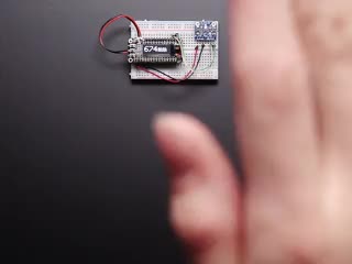 Video of a white hand hovering over a Adafruit VL53L0X Time of Flight Distance Sensor that's connected to a white breadboard reading the range of motion of the white hand. 