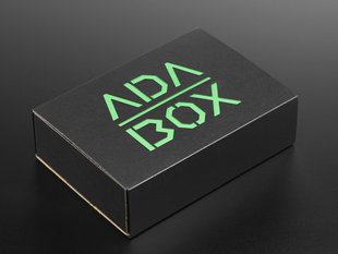 Angled shot of a black box with Green "ADABOX" texted logo.