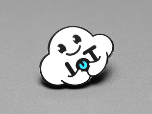 Angled shot of an enamel pin resembling an friendly cloud entity.