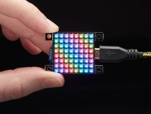 Hand holding small Adafruit DotStar High Density 8x8 Grid - 64 RGB LED Pixel Matrix