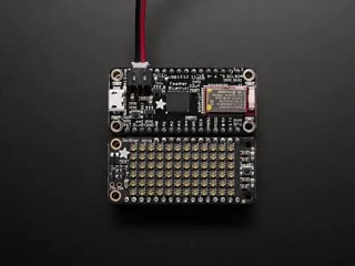 Video of a Adafruit DotStar FeatherWing connected to a featherwing. Display reads "ADAFRUIT!" in rainbow color pixel. 