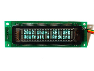 20x2 Character Vacuum Fluorescent Display lit up with text "20x2 char. SPI VFD. Adafruit heart Arduino"