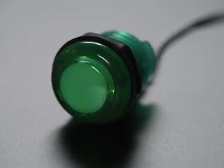 Video of 30mm translucent green LED arcade button flashing on and off.