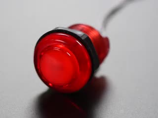Video of 30mm translucent red LED arcade button flashing on and off.