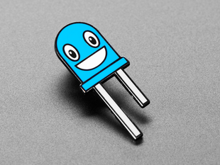 Angled shot of an enamel pin resembling a happy blue LED.