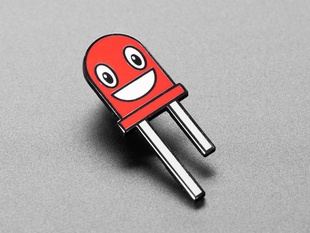 Angled shot of an enamel pin resembling a happy red LED.