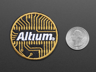 Circular embroidered badge with the word Altium in white over an abstracted orange circuit board design on a black background, with orange trim. 
