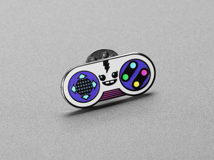 Angled shot of an enamel pin resembling a friendly remote controller.