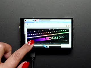 Red polished finger scrolling through the adafruit website on a Pimoroni HyperPixel - 4.0" Hi-Res Display for Raspberry Pi. 