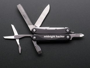mini pocket tool with knife, scissors and screwdrivers open.