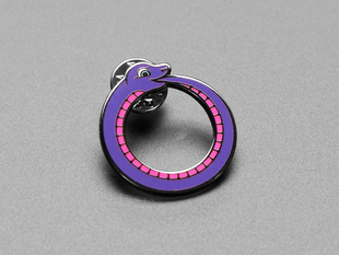 Angled shot of an enamel pin resembling a purple-and-pink python.