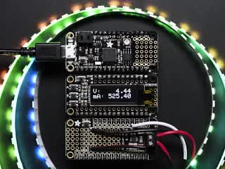 A feather and INA219 featherwing measure the dynamic voltage and current of an animating LED strip and display it on an OLED.