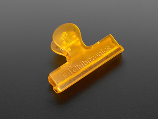Angled shot of plastic orange clip.
