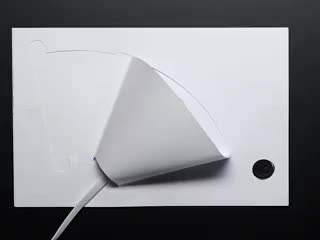 Hand touching a capacitive button to turn on and off a paper lamp