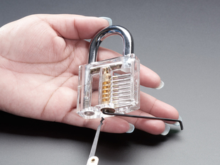 Person lock-picking a clear padlock