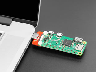 Angled shot of a Zero Stem for Pi Zero 1.3 and Pi Zero W 1.1 connected to Pi Zero and inserted into a macbook. 