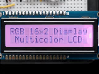 LCD wired on breadboard with backlight changing color with text displayed: "RGB 16x Display Mulitcolor LCD"