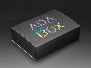 Angled shot of a black box with Rainbow trellis "ADABOX" texted logo.