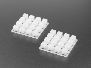 Angled shot of two white 4x4 silicone elastomer button keypads.