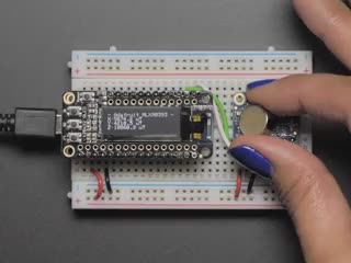 Video of a white hand with purple polished nails moving a battery above a Adafruit Wide-Range Triple-axis Magnetometer. 