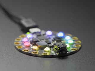 Circuit Playground with crystals on 10 LEDs, glowing rainbow