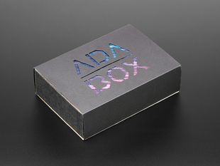 Angled shot of a black box with Galaxy like color "ADABOX" texted logo.