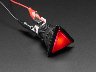Angled shot of a red triangle illuminated LED pushbutton. 