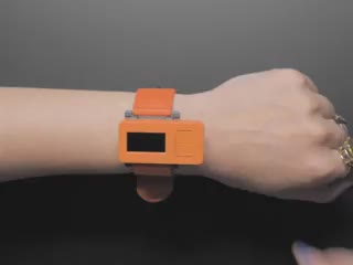 Video of a white hand with an electronic watch kit. They shake their wrist, causing the display to change its dice animation.