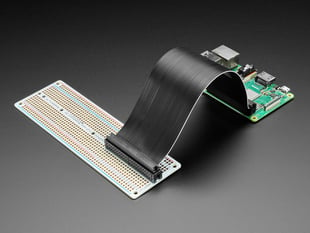 Angled shot of assembled Adafruit Perma-Proto 40-Pin Raspberry Pi Breadboard PCB with a Raspberry Pi 4.