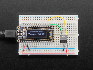 TC74A0 Breadboard Friendly I2C Temperature Sensor plugged into breadboard wired to Feather displaying the temperature