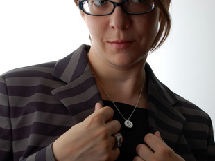 Woman wearing metal necklace with power button icon 