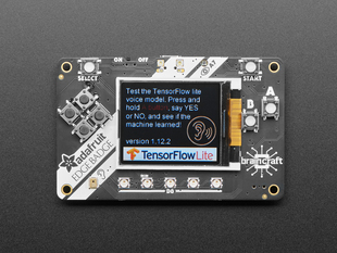 Top view of Adafruit EdgeBadge - Display reads "Test the TensorFlow lite voice model. Press and hold A button, say YES or NO, and see if the machine learned!".