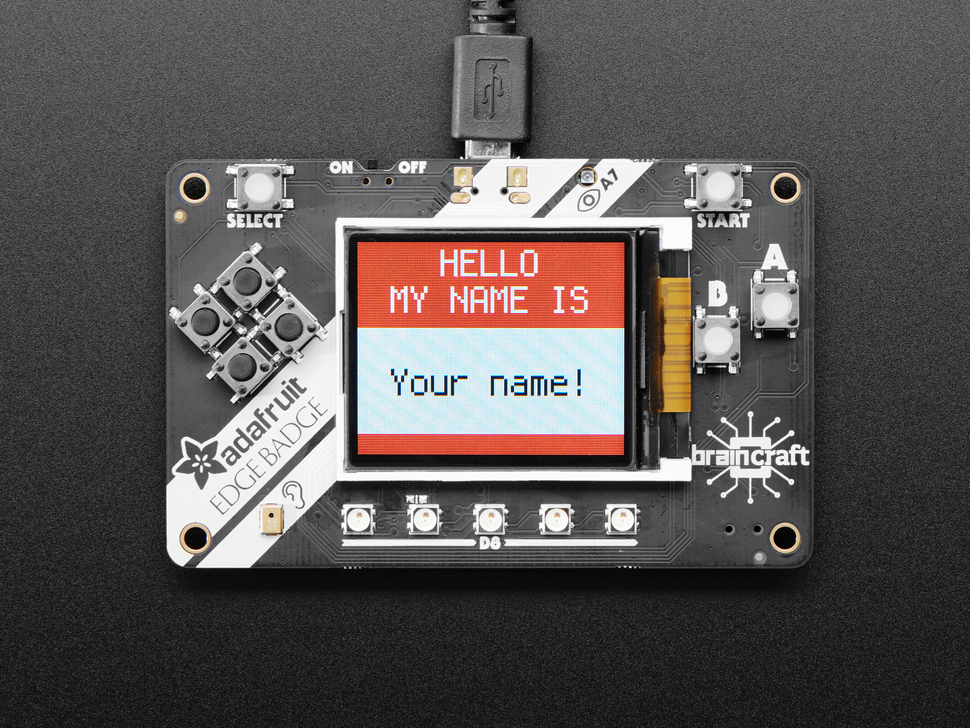 Top view of Adafruit EdgeBadge - display reads "HELLO MY NAME IS" in the red area then "Your name!" in the white area .