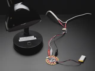 Demo lamp connected to a circuit playground and a Stemma with alligator clips. 