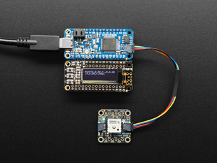Adafruit Mini GPS PA1010D wired up to a Feather with OLED via QT cable