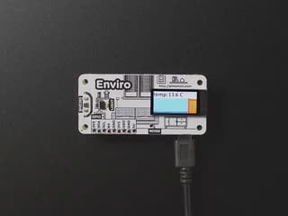 Video of a white hand pressing a button on a powered Pimoroni Enviro – Indoor Environmental Monitor for RaspPi.