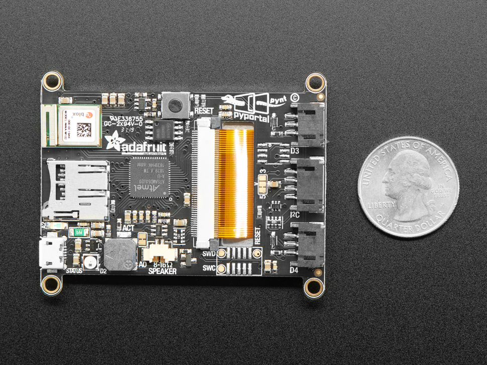 Top down shot showing back of board with chips and modules next to US quarter for scale. 