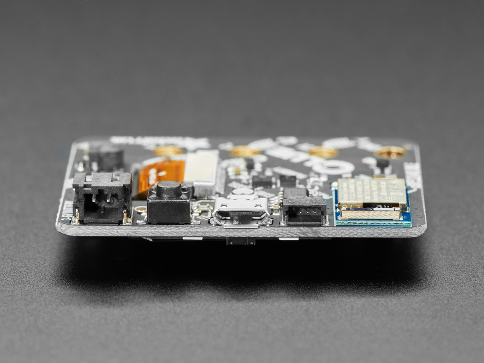 Close-up of long side showing JST battery port, reset button, micro USB port, Stemma QT port.