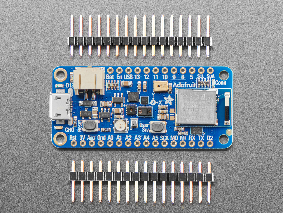 Overhead shot of blue, rectangular, microcontroller sandwiched between two pieces of 16-pin header.