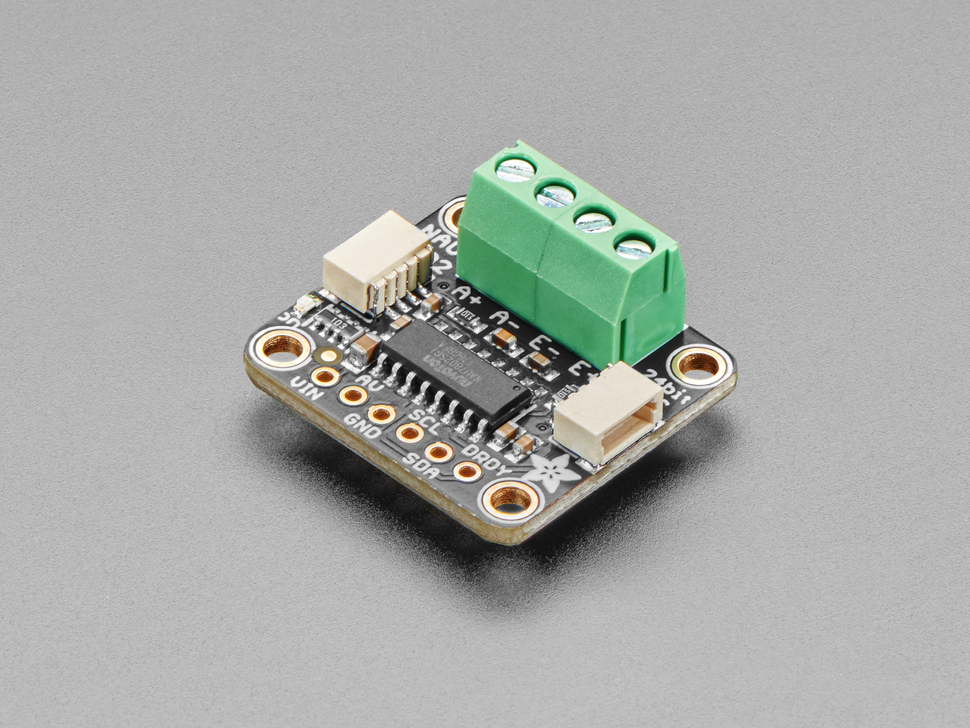 Angled shot of DAC breakout board with green terminal blocks.