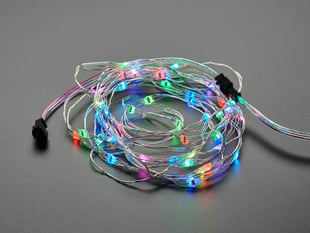 Adafruit Soft Flexible Wire NeoPixel Strand, coiled up and lit in rainbows
